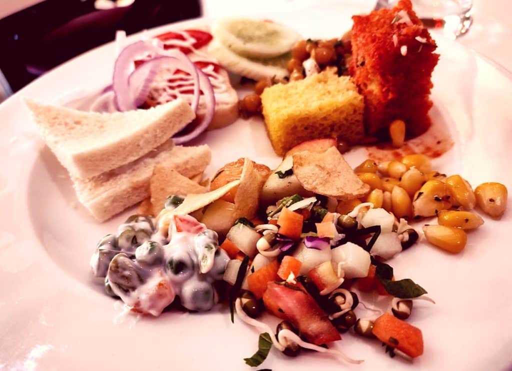 Image of delicious Indian food dishes, including sweets and savories, served on plates at Bikanervala restaurant in Hyderabad, India.